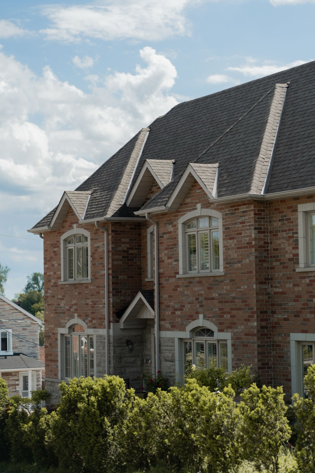 Brick home with a premium roof replacement in North Texas